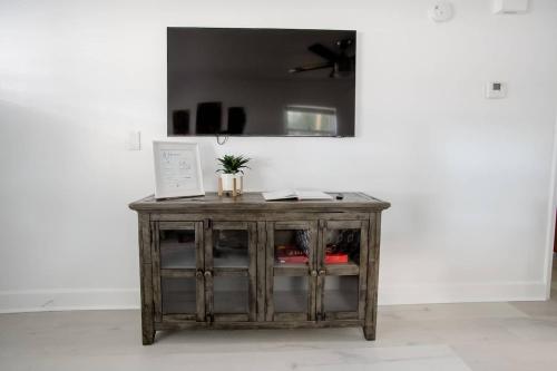 a wooden cabinet with glass doors in a room at Charming 1-bedroom Oasis In The Heart Of Downtown in New Port Richey