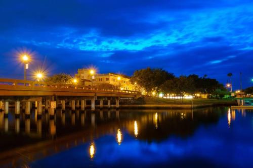 a bridge over a body of water at night at Charming 1-bedroom Oasis In The Heart Of Downtown in New Port Richey