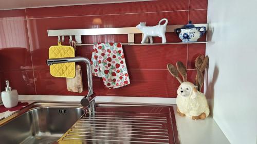 a kitchen counter with a sink and a shelf with towels at Holiday Home Paula in Krk