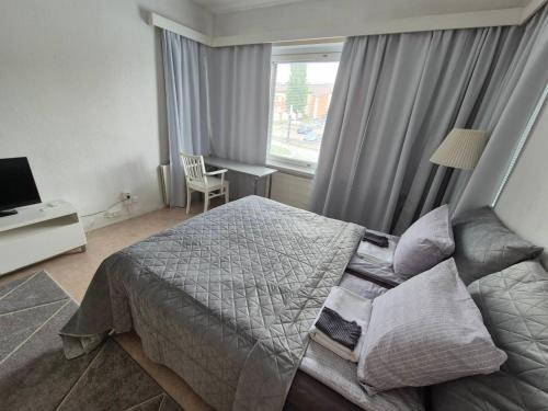 a hotel room with a bed and a window at Central Accommodation at Olavinkatu in Savonlinna