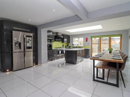a kitchen with stainless steel appliances and a wooden table at The Bullseye in Stonehouse
