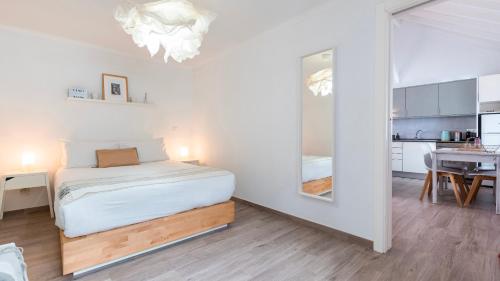 a small bedroom with a bed and a kitchen at Cozy Retreat with Patio Near Sintra by LovelyStay in Colares