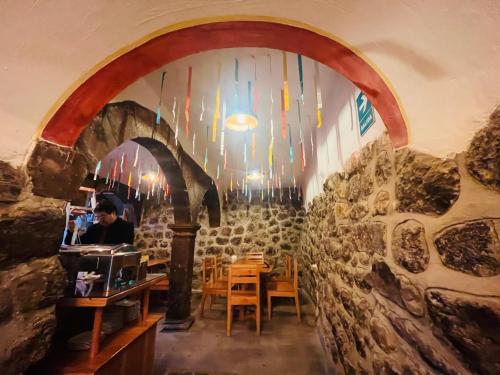 a man is sitting at a table in a restaurant at Rojas Plaza Boutique in Cusco