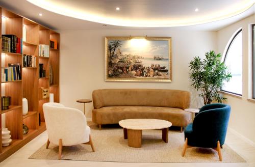 a living room with a couch and chairs at Hotel Apartamento Sinerama in Sines
