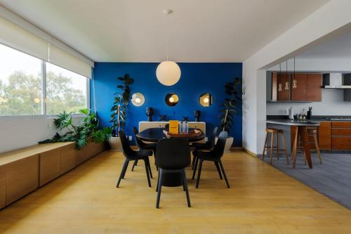 a kitchen and dining room with a blue wall at Amazing 3BR near Parque México in Condesa in Mexico City