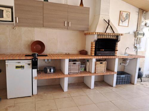 a kitchen with wooden shelves and a stove at CASA MOSTEIROS in Viegas