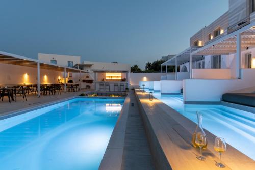 a villa with a swimming pool at night at Quartano Suites by Heliessa, Adults Only in Naousa