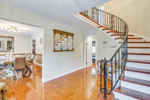 a living room with a staircase and a dining room at Hidden Paradise on 5 Acres with Hot Tub and Deck! in Black Jack