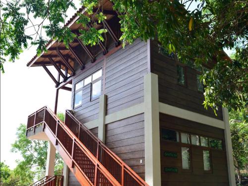 a house with a balcony on the side of it at Pacaya Lodge and Spa in La Laguna