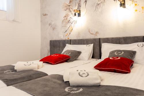 two beds with red and white pillows on them at Los Geranios 307 in Adeje