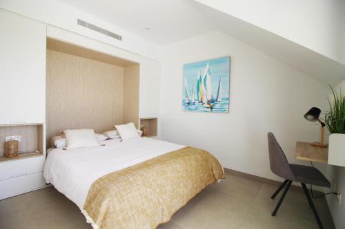 a white bedroom with a bed and a desk at Three Bedroom Seaside Penthouse In Mar De Cristal in Mar de Cristal