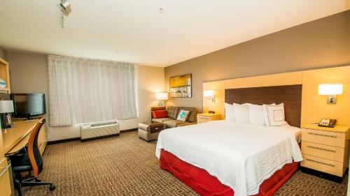 a hotel room with a bed and a television at TownePlace Suites by Marriott Scranton Wilkes-Barre in Moosic