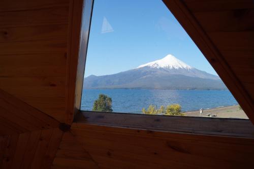 a view of a snow covered mountain from a window at Cabañas Domos May-Ling in Ensenada