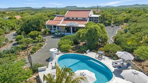 an aerial view of a house with a swimming pool at Villa San Sebastian Curaçao in Fontein