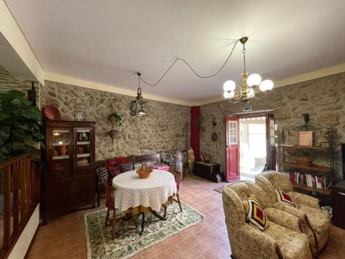 a living room with a table and a couch at Casa dos Cabencos in Terras de Bouro