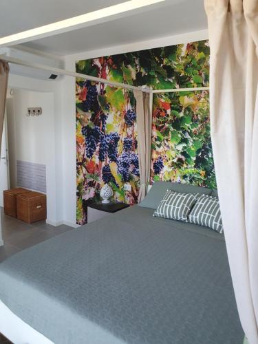 a bed in a room with a painting on the wall at La casa di Igni in San Donà di Piave
