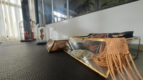 a room with a bed and a clock on the floor at Les Appartements du 104 in Saint-Jean-de-Monts