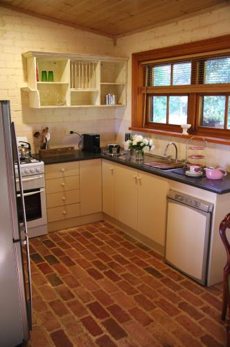 a kitchen with a refrigerator and a stove top oven at Pear Tree Hollow in Bald Hills