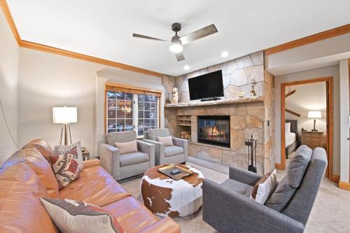 a living room with a couch and a fireplace at The Charter at Beaver Creek C020 in Beaver Creek