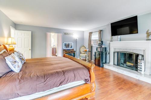 a bedroom with a bed and a fireplace at Hidden Paradise on 5 Acres with Hot Tub and Deck! in Black Jack