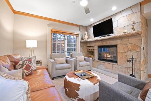 a living room with a couch and a fireplace at The Charter at Beaver Creek C020 in Beaver Creek