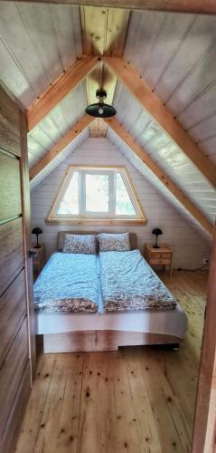a bed in a small room with a window at FreeDom House in Dolina