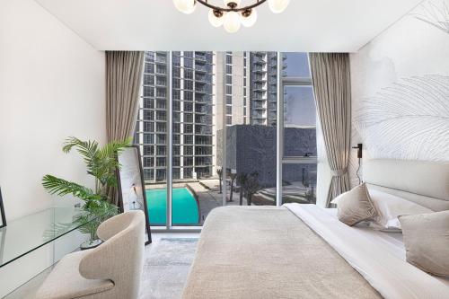 a bedroom with a bed and a view of a building at Exclusive 1BR District 1 - Crystal Lagoon Access in Dubai