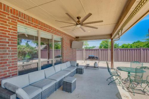 a patio with a couch and a table and a ceiling fan at Sunny Stephenville Home with Pool 4 Mi to Downtown in Stephenville