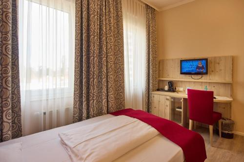 Televisyen dan/atau pusat hiburan di TRIP INN PostHotel Düren