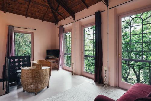 an open living room with large windows at Villa Liverzano in Brisighella
