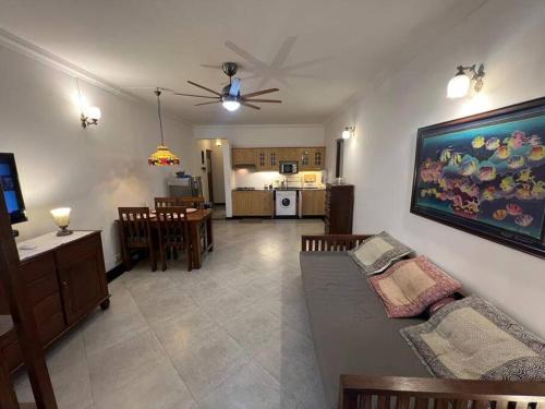 a living room with a couch and a dining room at Cim and Sands in Goa