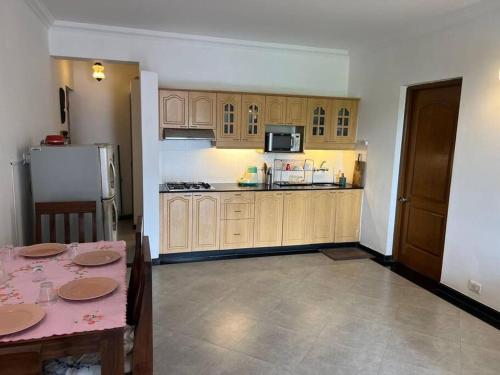 a kitchen with a table and a refrigerator at Cim and Sands in Goa