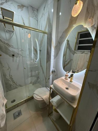 a bathroom with a sink and a shower and a toilet at Design Loft - Near Copacabana Palace Hotel and Copacabana Beach in Rio de Janeiro