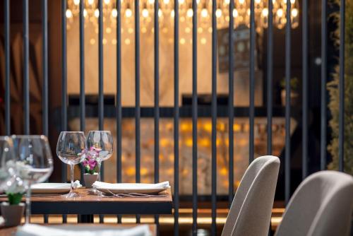a table with chairs and wine glasses on it at Gleam Bomonti Hotel in Istanbul
