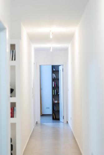 an empty hallway with white walls and a book shelf at Mgarr ix-Xini, B5 in Xewkija