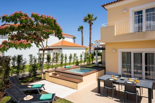 a backyard with a swimming pool and a house at Eden Villas & Apartments in Albufeira