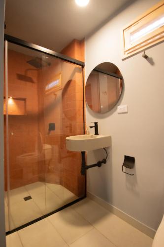 a bathroom with a sink and a shower at Leviu by Bernalo Hotels in Medellín