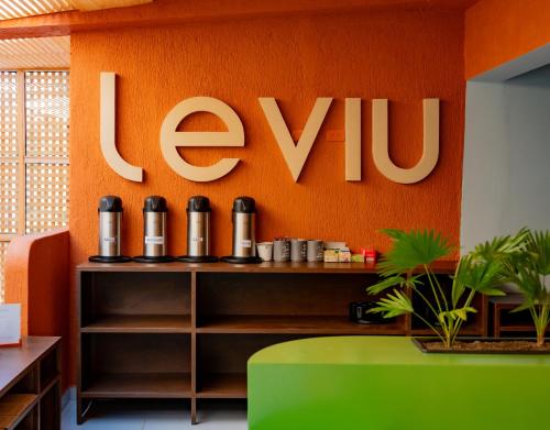 an orange wall with the word evu on it at Leviu by Bernalo Hotels in Medellín