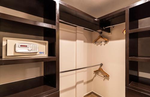 a walk in shower in a bathroom with a microwave at Grand Chapultepec Residencial in Mexico City
