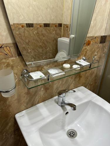 a bathroom with a white sink and a mirror at Pensiunea Balea in Cîmpeni