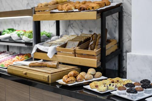 a display case with different types of breads and pastries at Gleam Bomonti Hotel in Istanbul