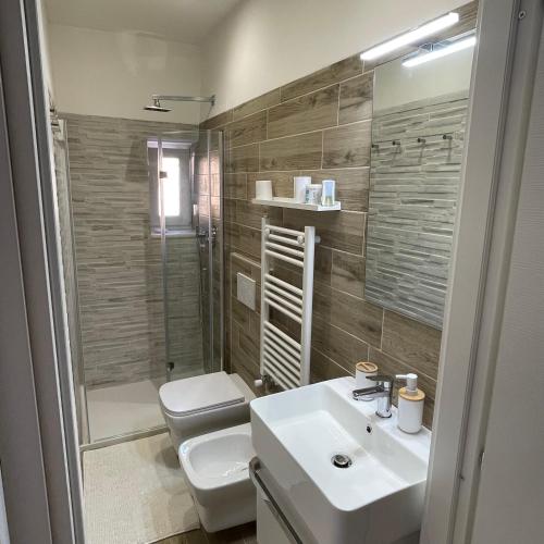 a bathroom with a sink and a toilet and a shower at Casa Rebocco in La Spezia