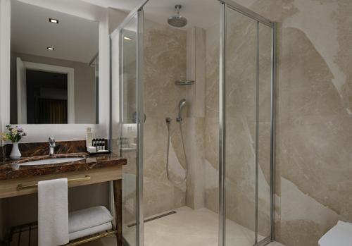 a bathroom with a shower and a sink at Gleam Bomonti Hotel in Istanbul
