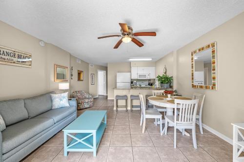 a living room with a couch and a table at Tradewinds 307 in Orange Beach
