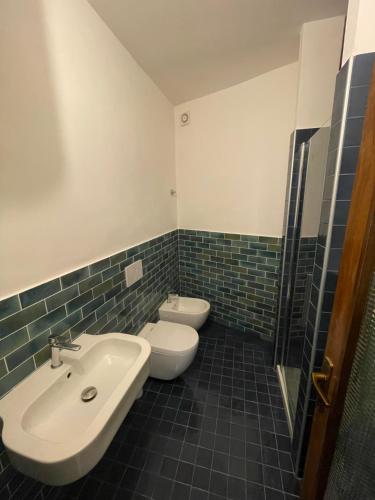 a bathroom with a sink and a toilet in it at Via della Campana 17 in Portoferraio
