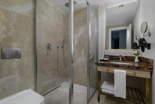 a bathroom with a shower and a sink at Gleam Bomonti Hotel in Istanbul