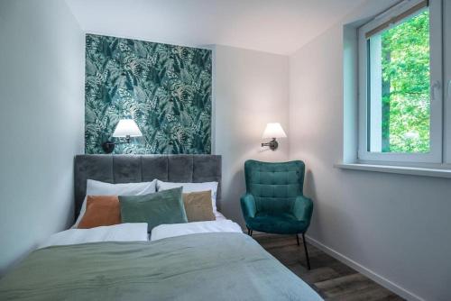 Кровать или кровати в номере VacationClub - Podgórzyńska 6A apartament 6