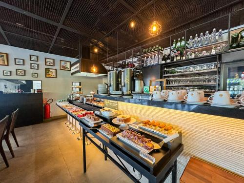 a restaurant with a counter with food on display at Pousada Papiro Boutique in Abraão