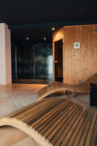 a wooden bench sitting inside of a building at Villa Liverzano in Brisighella