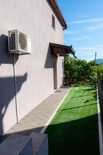 a house with a air conditioner on the side of it at Apartman Divna in Ljubuški